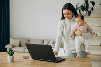 Mutter mit Baby vor Computer Mutter mit Baby vor Computer © designed by Freepik